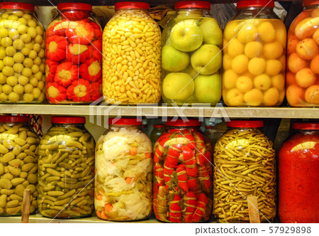 Pickled vegetables in glass jars on the market. Pickled vegetables in glass jars on the market. 57929898