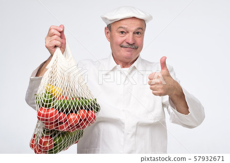 Cook chef holding white eco cotton string bag 57932671