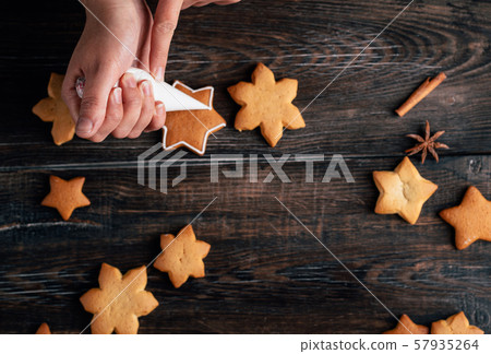 Friends decorating christmas gingerbread cookies Friends decorating christmas gingerbread cookies 57935264