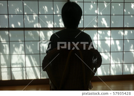 A person sitting in front of shoji 57935428