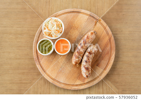Grilled sausages. Serving on a wooden Board. Barbecue restaurant menu, a series of photos of Grilled sausages. Serving on a wooden Board. Barbecue restaurant menu, a series of photos of 57936052