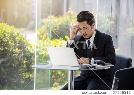 stressed business man using laptop and working 57936511