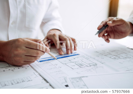 Architects or engineering working with blueprints 57937666