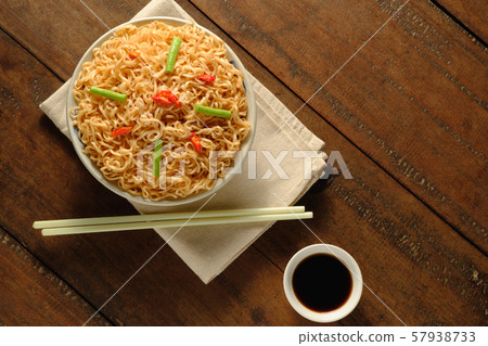 Instant noodles in a bowl with a cloth placed on a 57938733