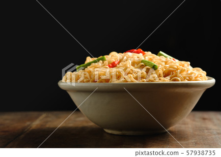 Instant noodles in a bowl, placed on a wooden,copy 57938735