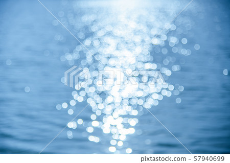Bokeh on the water surface the background. Bokeh on the water surface the background. 57940699