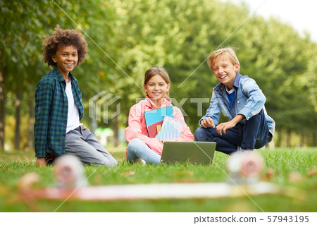 Group of friends sitting outdoors Group of friends sitting outdoors 57943195