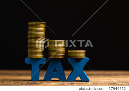 TAX concept. TAX alphabet with stack of coin on TAX concept. TAX alphabet with stack of coin on 57944352