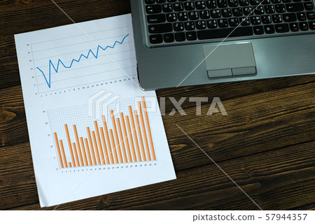 Notebook laptop computer and financial graph on Notebook laptop computer and financial graph on 57944357