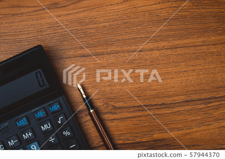 Fountain pen or ink pen with calculator on wooden Fountain pen or ink pen with calculator on wooden 57944370