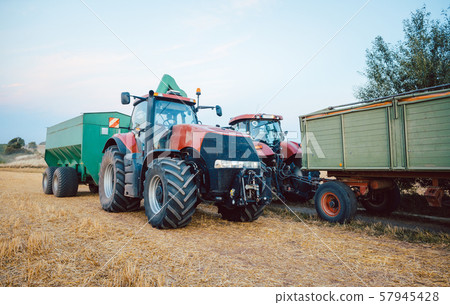Agricultural machinery and tractor on a harvested field Agricultural machinery and tractor on a harvested field 57945428