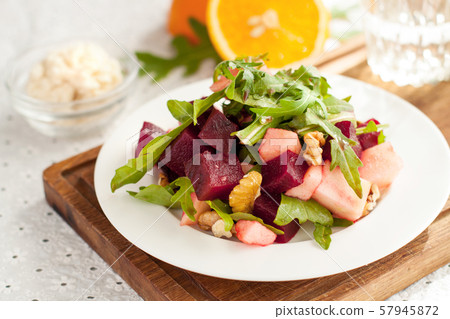 Salad with apple, beet, arugula and walnuts Salad with apple, beet, arugula and walnuts 57945872