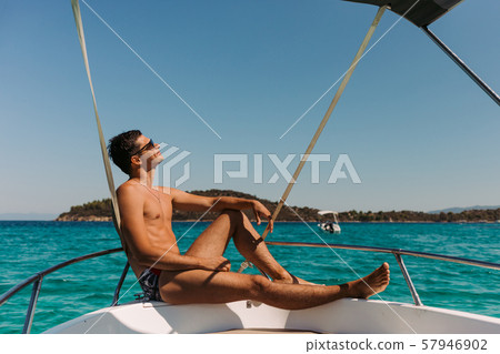 man relaxing on yacht in the sea. man relaxing on yacht in the sea. 57946902