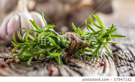 Fresh rosemary and garlic cloves with spices on 57947182