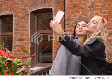 two girls take a selfie with duck face 57948203