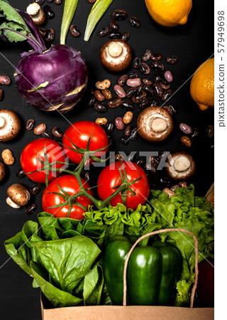 Different fresh vegetables and bread in shopping paper bag. Purchases concept. Healthy food organic 57949698