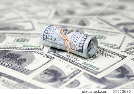 US dollars rolled up and tightened with band lies US dollars rolled up and tightened with band lies 57950680