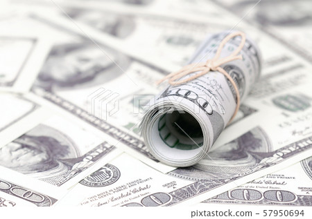 US dollars rolled up and tightened with band lies US dollars rolled up and tightened with band lies 57950694