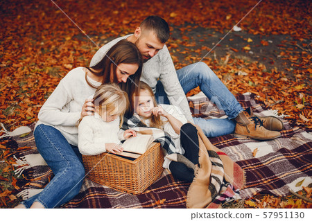Family with cute kids in a autumn park Family with cute kids in a autumn park 57951130