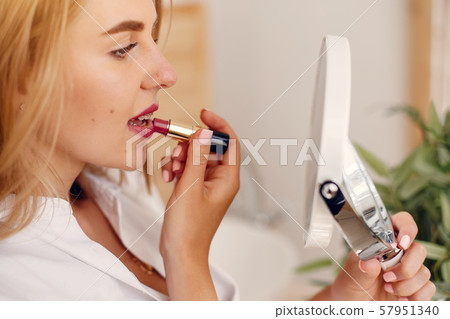 Beautiful woman standing in a bathroom Beautiful woman standing in a bathroom 57951340