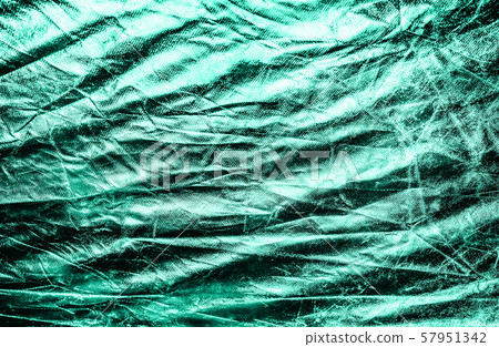 Shiny crumpled surface of silver foil in trendy mint color for textured background. Shiny crumpled surface of silver foil in trendy mint color for textured background. 57951342
