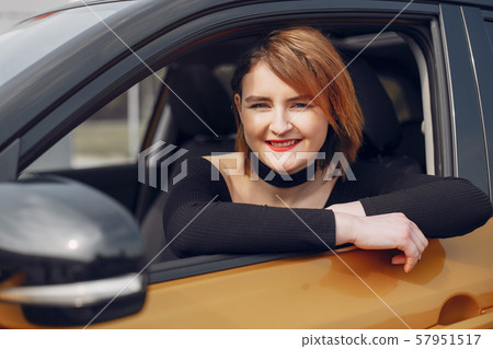 Stylish and elegant woman in a car salon Stylish and elegant woman in a car salon 57951517