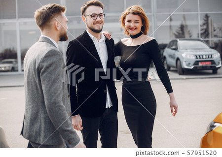 Stylish and elegant couple in a car salon 57951520