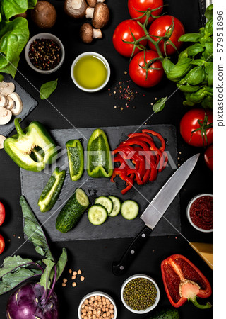 Raw ingredients for cooking vegetarian healthy food. Flat lay of vegetables and cheese on a black 57951896