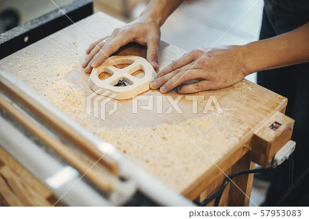 The carpenter works with a tree 57953083