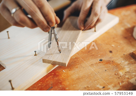 The carpenter works with a tree 57953149