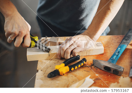 The carpenter works with a tree The carpenter works with a tree 57953167