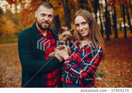 Elegant couple spend time in a autumn park Elegant couple spend time in a autumn park 57954278
