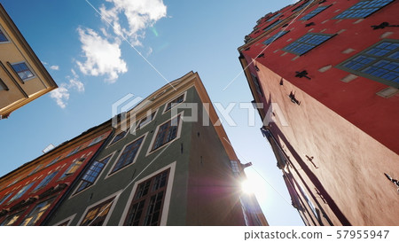 Multicolored old houses in Stockholm. Beautiful European architecture, the sun shines from behind Multicolored old houses in Stockholm. Beautiful European architecture, the sun shines from behind 57955947