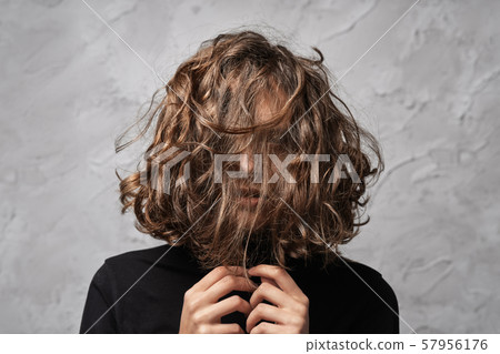 Closeup portrait of young lady with disheveled Closeup portrait of young lady with disheveled 57956176