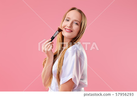 Happy smiling woman with blush and powder brush Happy smiling woman with blush and powder brush 57956293