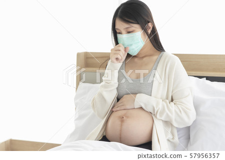 Young Asain woman coughing for effective caused of cold or influenza, wearing mask cover her face. Young Asain woman coughing for effective caused of cold or influenza, wearing mask cover her face. 57956357