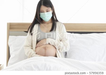 Young Asain woman coughing for effective caused of cold or influenza, wearing mask cover her face. Young Asain woman coughing for effective caused of cold or influenza, wearing mask cover her face. 57956359