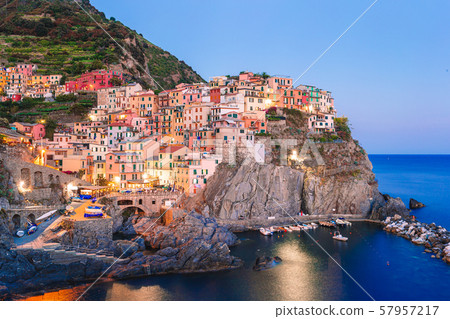 Stunning view of the beautiful and cozy village of Manarola in the Cinque Terre Reserve at sunset. Stunning view of the beautiful and cozy village of Manarola in the Cinque Terre Reserve at sunset. 57957217