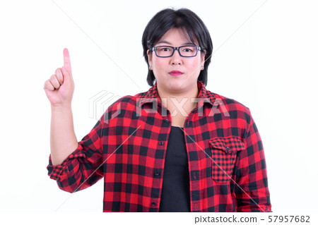 Beautiful overweight Asian hipster woman pointing up Beautiful overweight Asian hipster woman pointing up 57957682