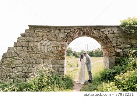 beautiful chinese couple, woman in luxury wedding dress and man in gray suit, standing in old beautiful chinese couple, woman in luxury wedding dress and man in gray suit, standing in old 57958231