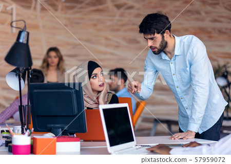 Multiethnic startup business team on meeting in modern bright office interior brainstorming, working 57959072