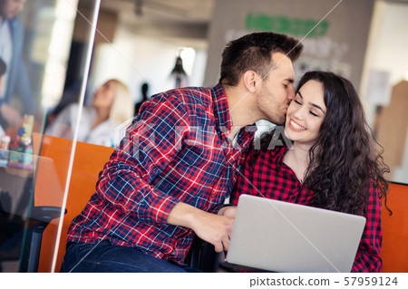 happy young couple kissing in the office - Stock Photo [57959124] - PIXTA