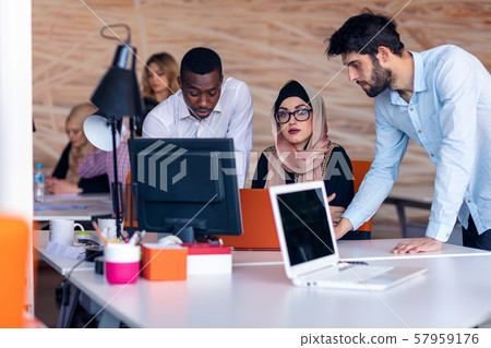 Multiethnic startup business team on meeting in modern bright office interior brainstorming, working 57959176