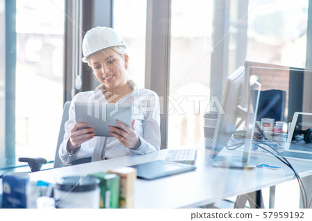 Female designer in office working on architects project 57959192