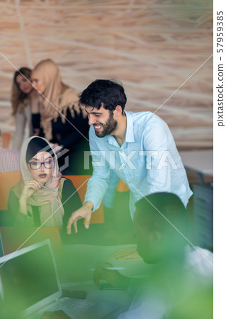 Multiethnic startup business team on meeting in modern bright office interior brainstorming, working Multiethnic startup business team on meeting in modern bright office interior brainstorming, working 57959385
