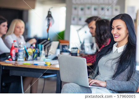 Creative business team working hard together in casual office Creative business team working hard together in casual office 57960005