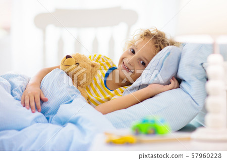 Child playing in bed. Kids room. Baby boy at home. 57960228