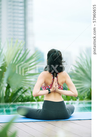 Woman doing yoga outdoors Woman doing yoga outdoors 57960655