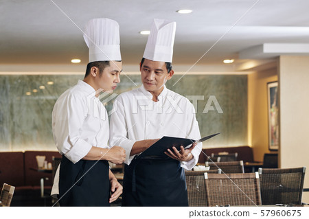 Two chefs working at the restaurant 57960675