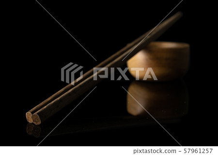 Asian chopsticks isolated on black glass Asian chopsticks isolated on black glass 57961257